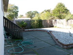 looking across the backyard from the right/garage side