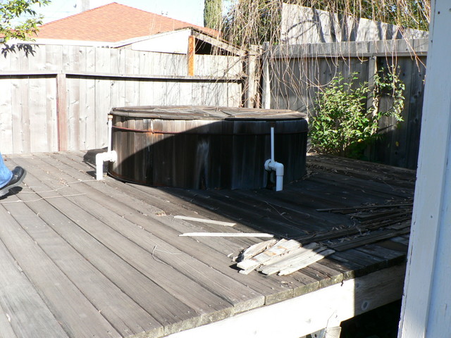 on the deck behind the shed is an All Original disrepaired hot tub