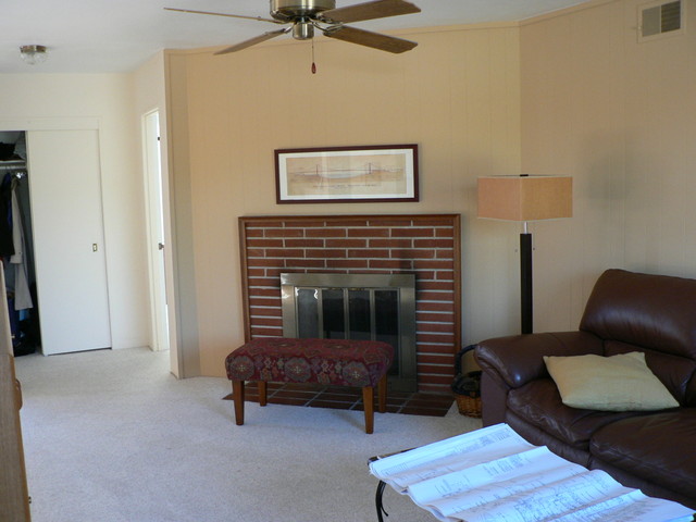 by the back door, looking at the livingroom, the front closet/door are just out of frame to the left, and the entrance to the bedrooms hall is "behind" the fireplace.  FIREPLACE !!