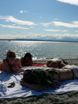 Erin, CQ, Adam and Jim.  On the beach, with the Olympics in the distance.