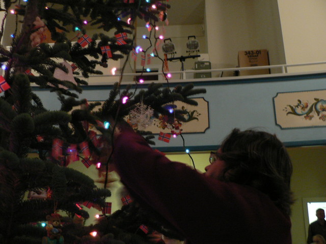 Jimmy puts his ornament on the tree