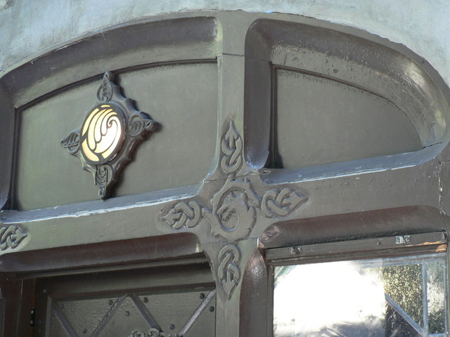 detail of a wolf-head on the front door