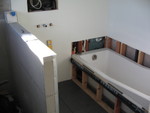 Most of the tub with the context of the sink area next to it
