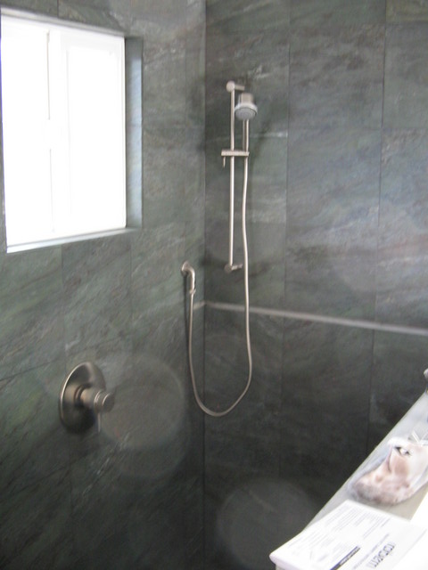 One of the shower heads is in place, the other will be in the ceiling. You can also see the control.