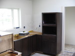 The tall cabinet is where the coffee maker and the microwave go. There's a lazy susan in the corner too.