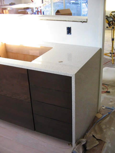 The counter goes across and then down the side of the cabinet. The hole is for the cooktop.