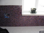 grouted backsplash to the left of the sink