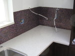 Grouted backsplash to the right of the sink