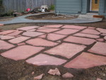 They completed the flagstone puzzle and filled in the gaps between with dirt.