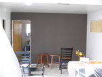 The brown wall in what was the dining room. Notice the window in the right wall has been made smaller.